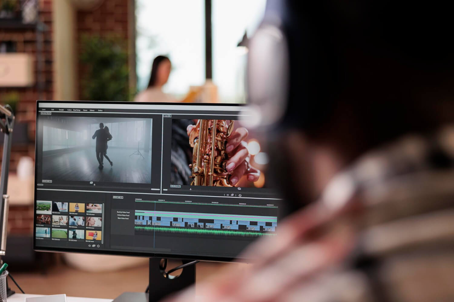 a person sitting in front of screen using ai editing tools